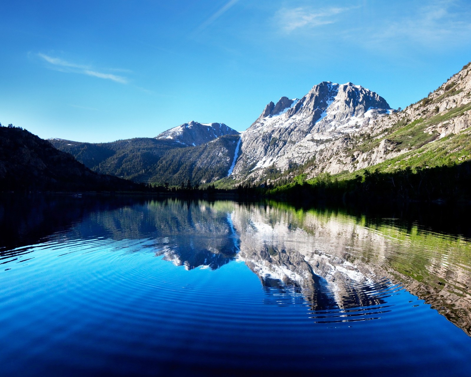 Montanhas refletidas em um lago com céu azul e nuvens (lago, margem do lago, montanha)