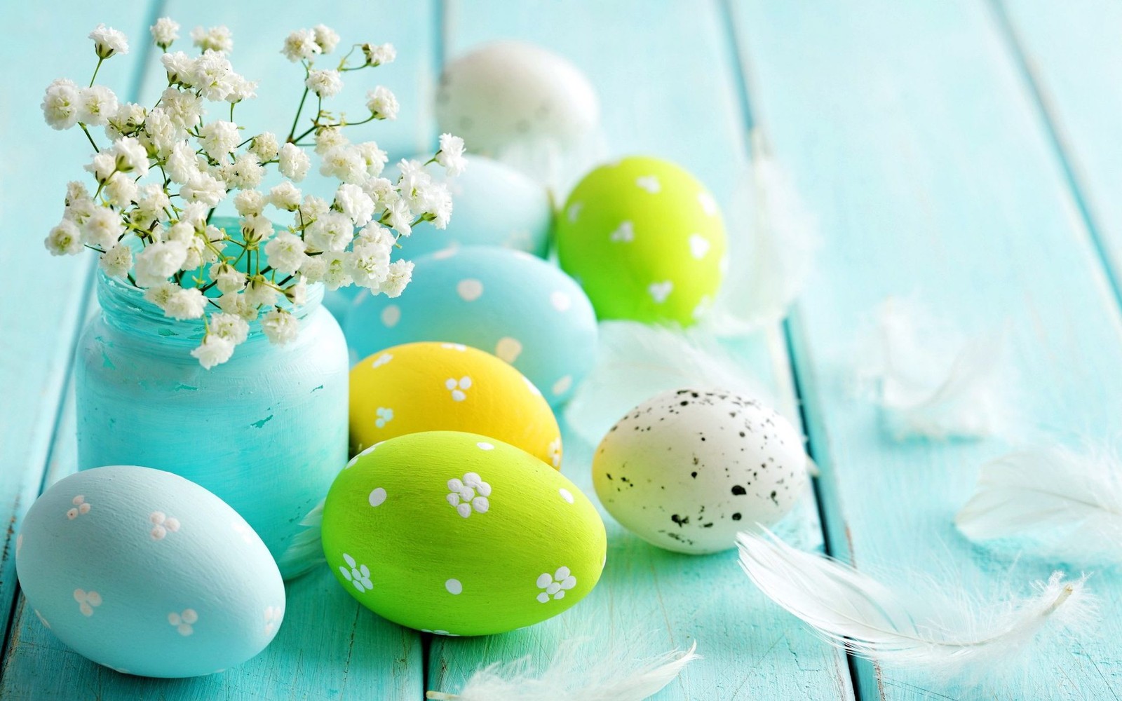 There are many eggs and flowers in a vase on a table (easter, eggs, plant)