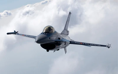 F-16 Multirole Fighter Jet in Flight Among Clouds