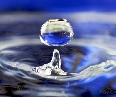 Suspended Water Drop on a Blue Rippled Surface