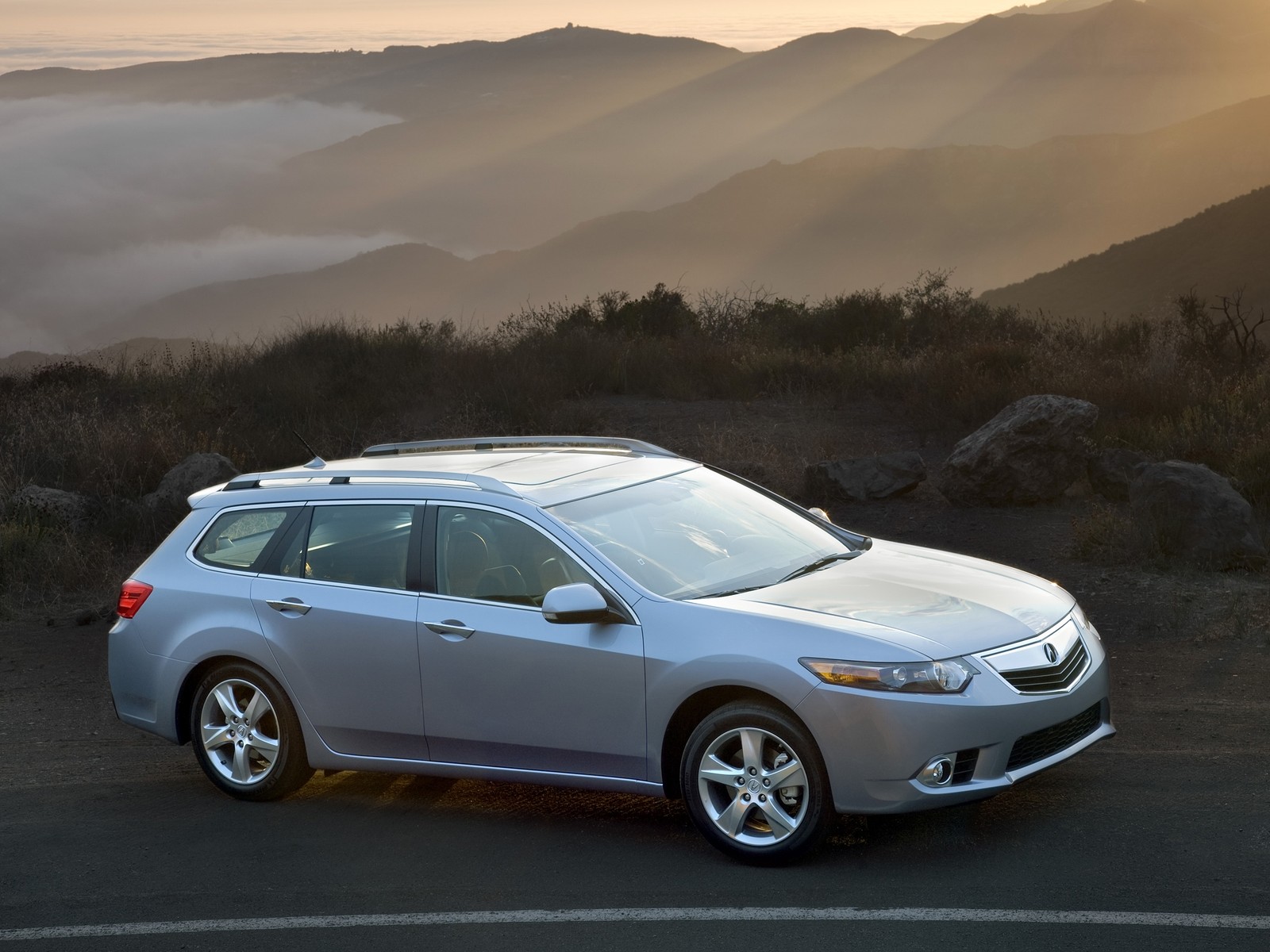 Arafed view of a silver car on a road with mountains in the background (acura, station wagon, honda accord, land vehicle, honda)