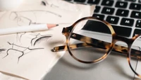 Fashionable Eyewear Design: Sketches and Eyeglasses on a Workspace