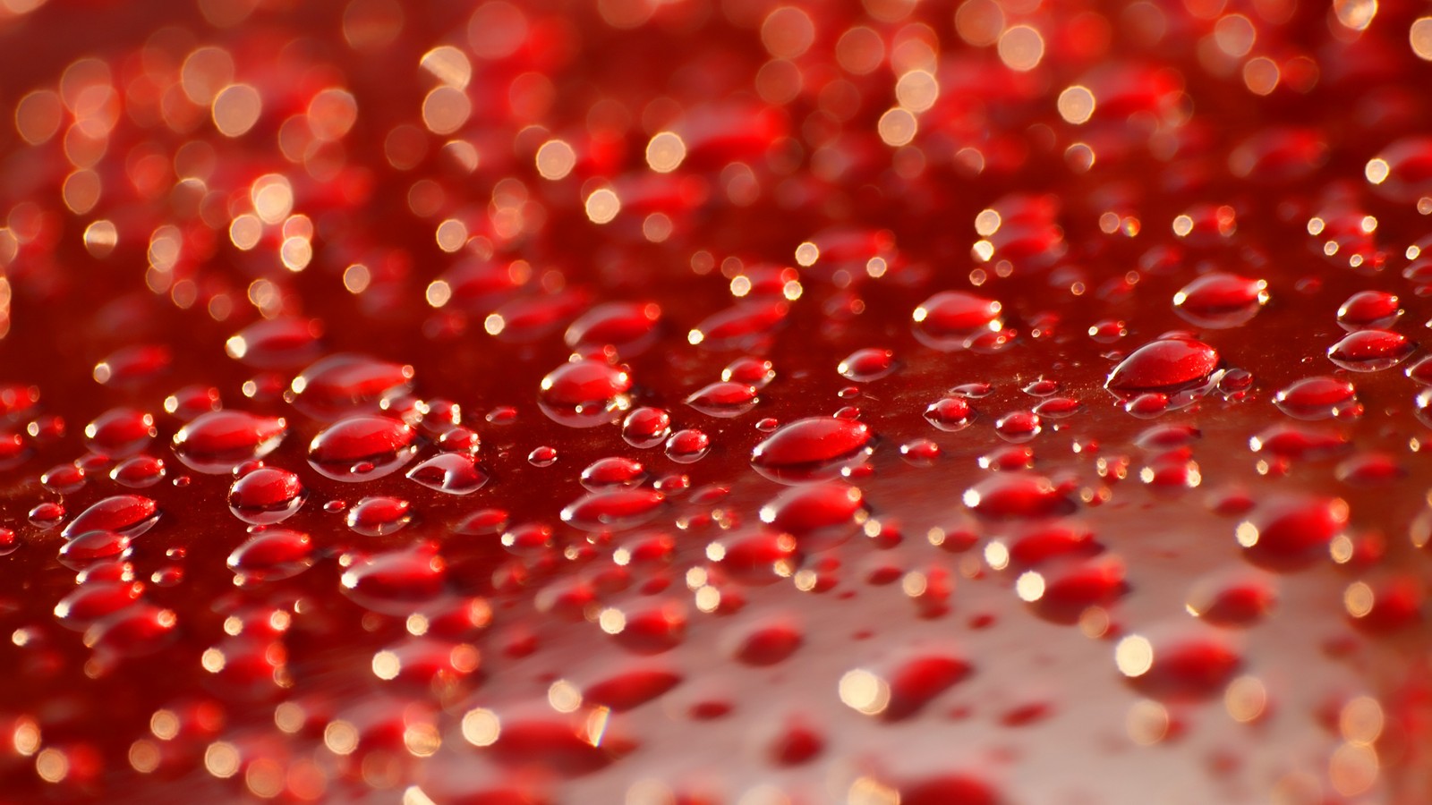 A close up of a red liquid filled with lots of water (water, liquid, fluid, magenta, pattern)