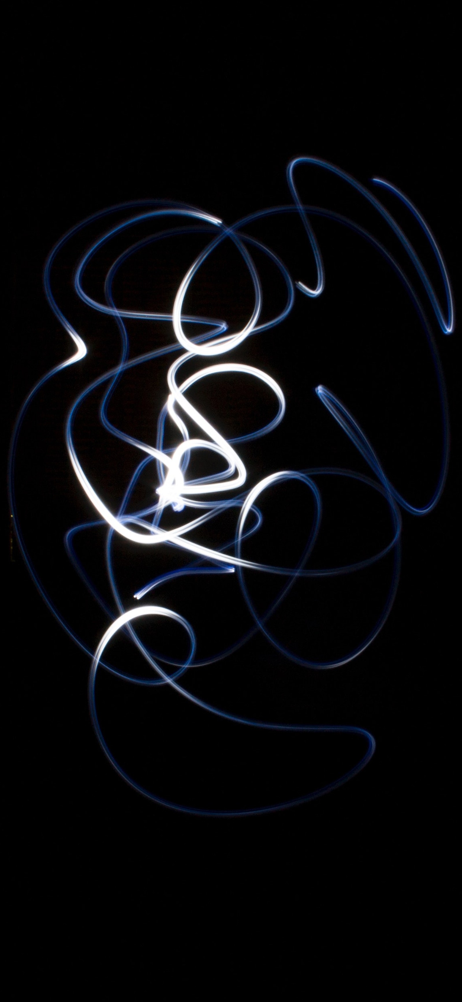 A close up of a light painting of a swirl of light (graphic design, light, art, calligraphy, apple)