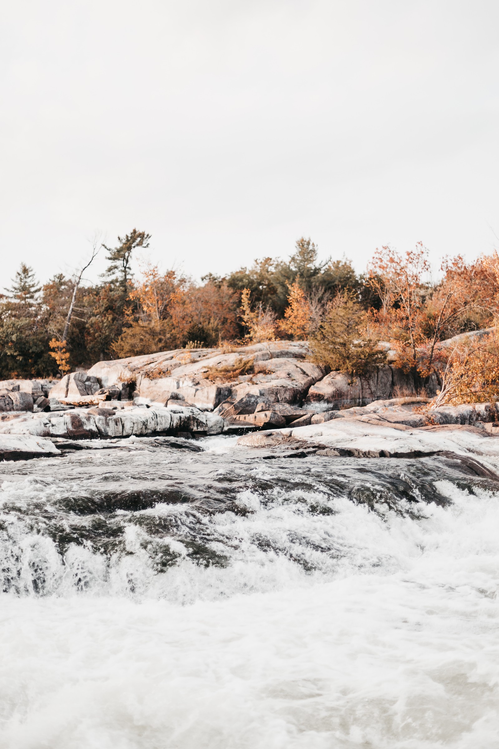 Un homme se tient sur un rocher dans l'eau (eau, paysage naturel, neige, hiver, sauvage)