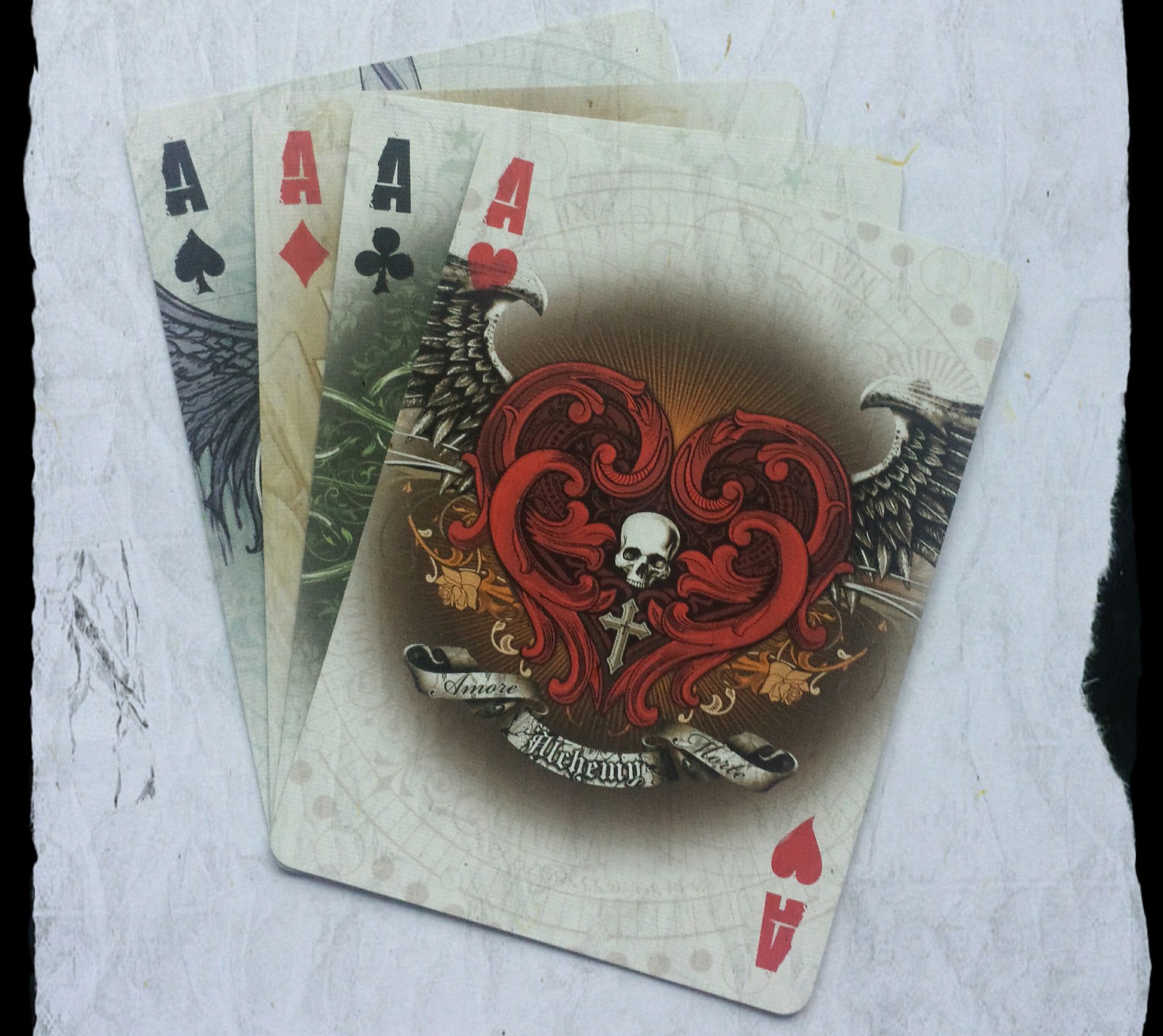 There are four playing cards with a skull and a heart on them (ace, cards, cool, galaxy s4, poker)