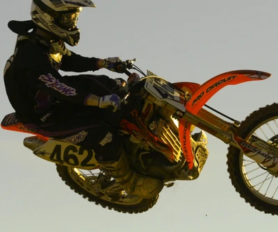 Motocross Rider Performing a Whip on a Honda Dirt Bike