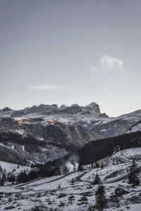 Majestic Alps at Sunset: A Winter Panorama of Snow-Covered Peaks and Serene Wilderness.