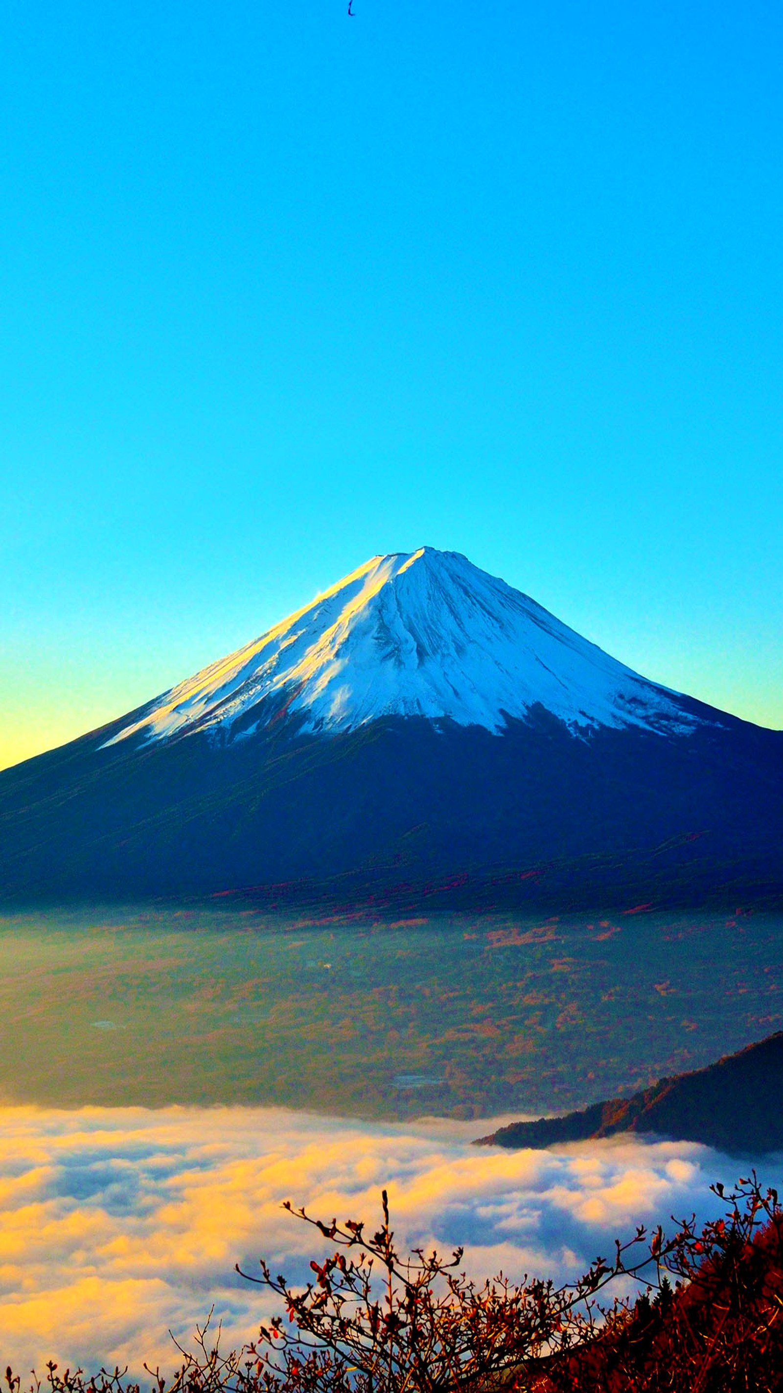 Arafed mountain with a snow covered peak in the distance (6 plus, mountain, mt fuji)