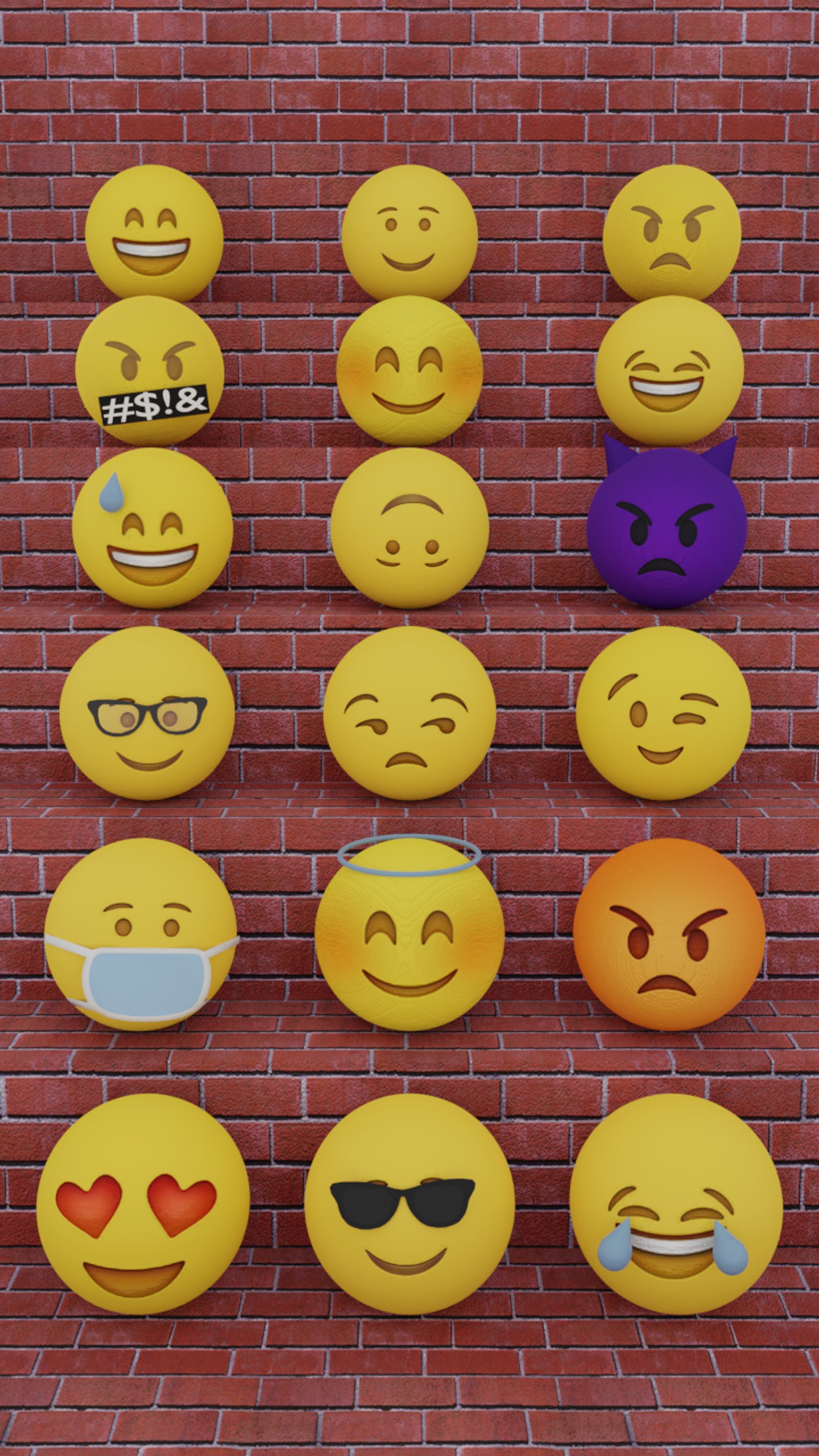 Un primer plano de una pared de ladrillos con muchas emociones diferentes (emoji, sonrisas, caras, risa, enojado)