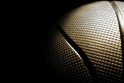 Close-Up of a Textured Basketball Against a Dark Background