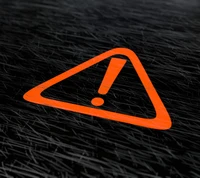 Orange warning sign on a dark background, symbolizing caution and alertness.