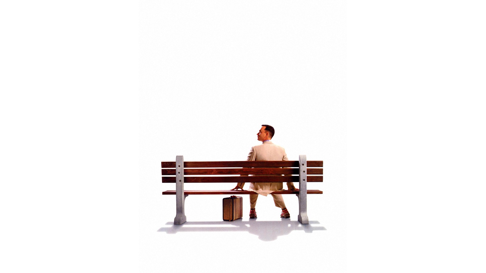 There is a man sitting on a bench with a suitcase (poster, film poster, furniture, bench, sitting)