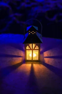 Cobalt Blue Lantern Illuminating a Dark Farmhouse Night