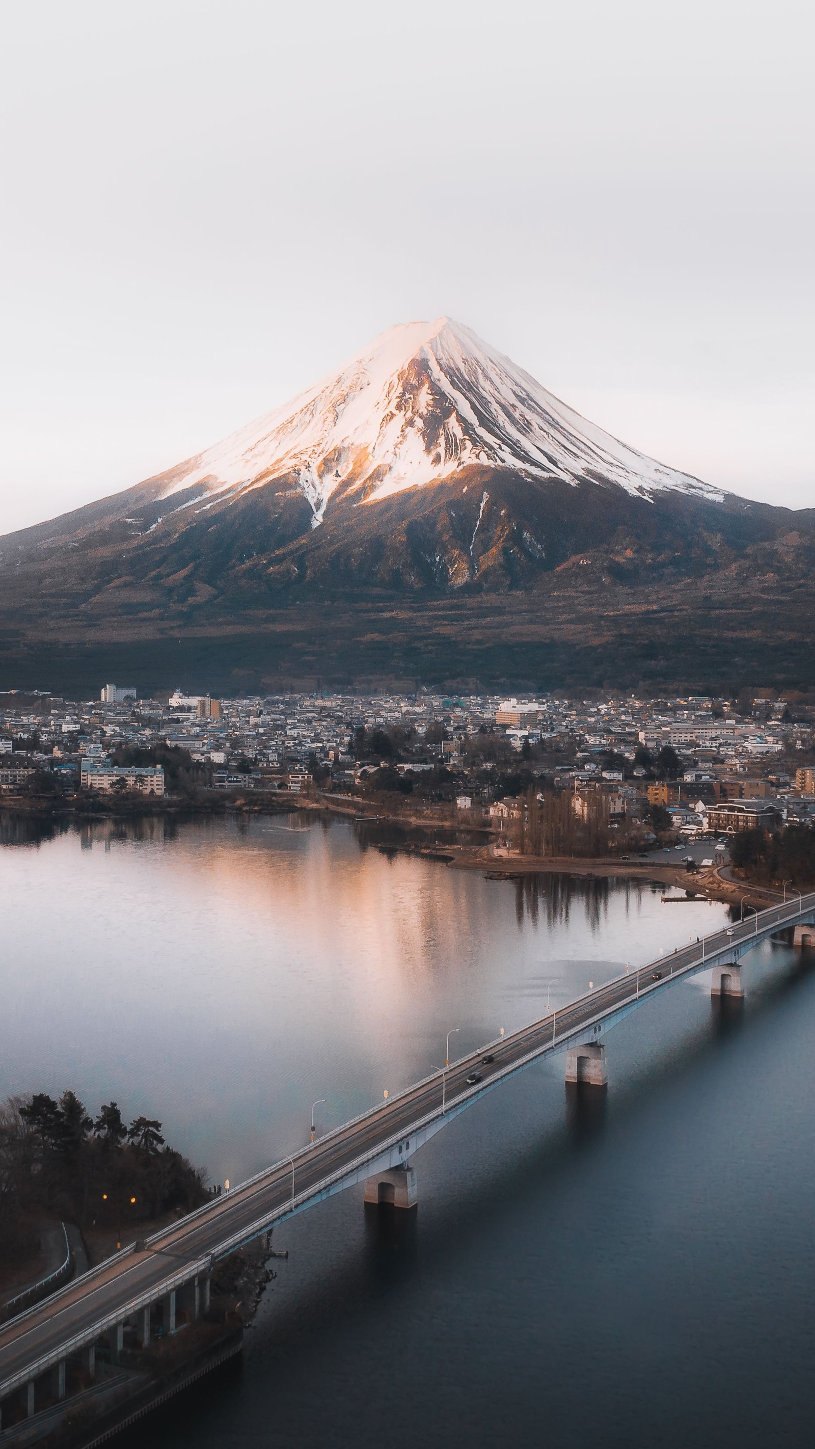 Arafed mountain in the distance with a bridge over a river (lake kawaguchi, mount fuji, mount scenery, mountain, water)