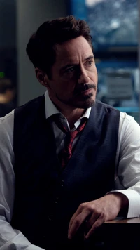 Tony Stark in a contemplative moment, dressed in a formal vest with a loosened tie.