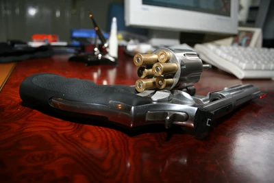 Colt Single Action Army Revolver with Loaded Cylinder on Desk