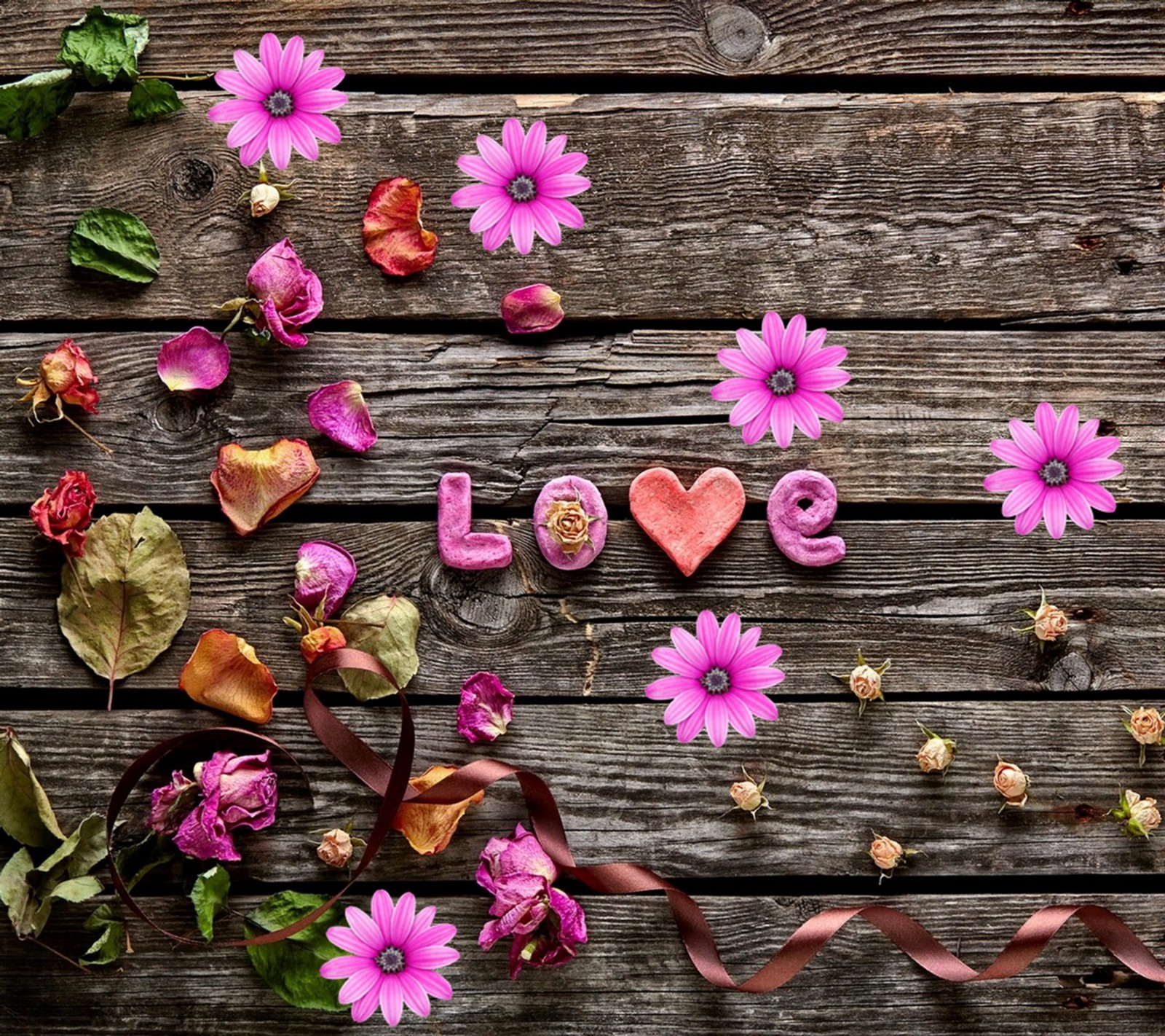 Flowers and leaves arranged on a wooden surface with a heart (flowers, spring)