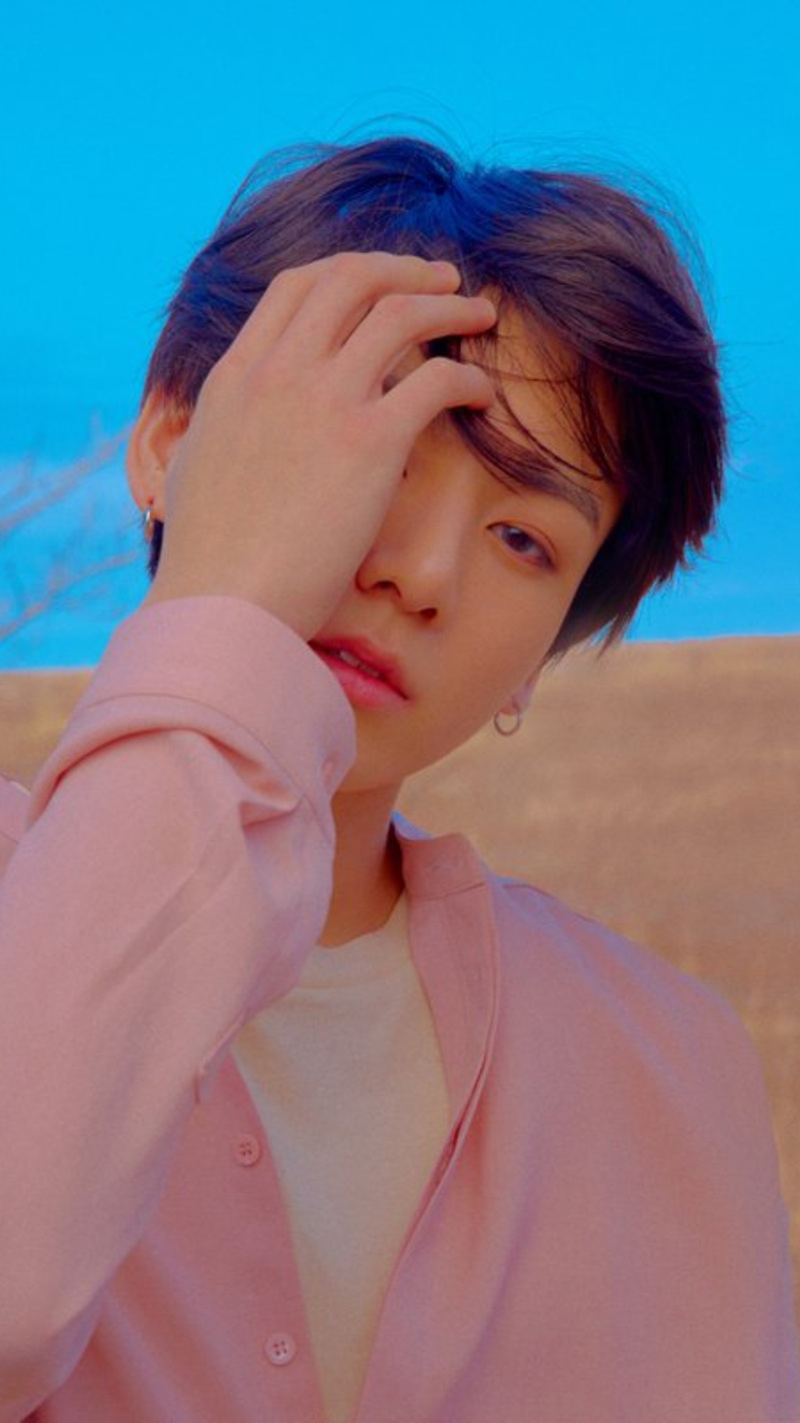 Un gros plan d'une personne tenant sa tête devant un ciel bleu (2018, bts, concept, jk, jungkook)