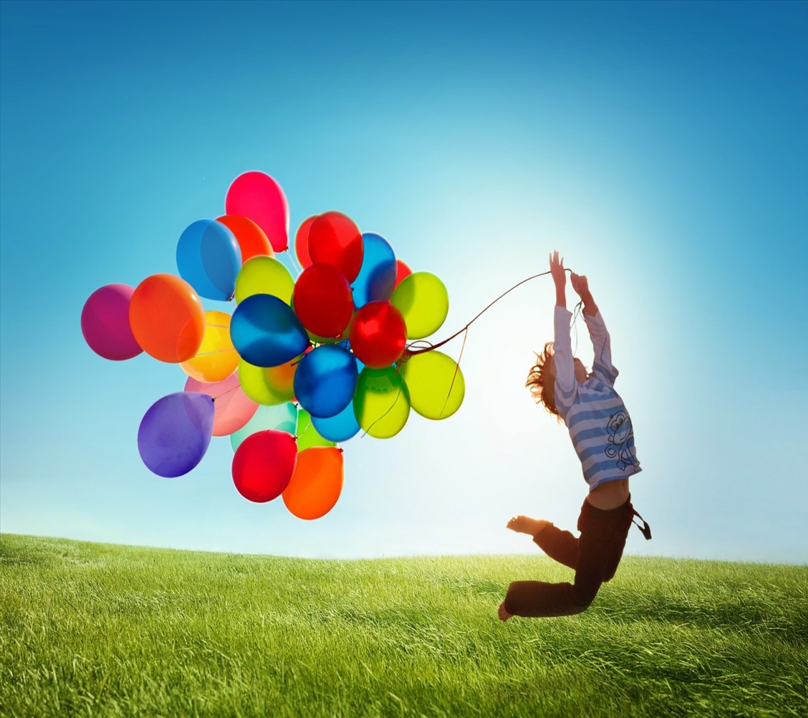 Arafed man jumping in the air with balloons in the air (galaxy s iv, samsung)