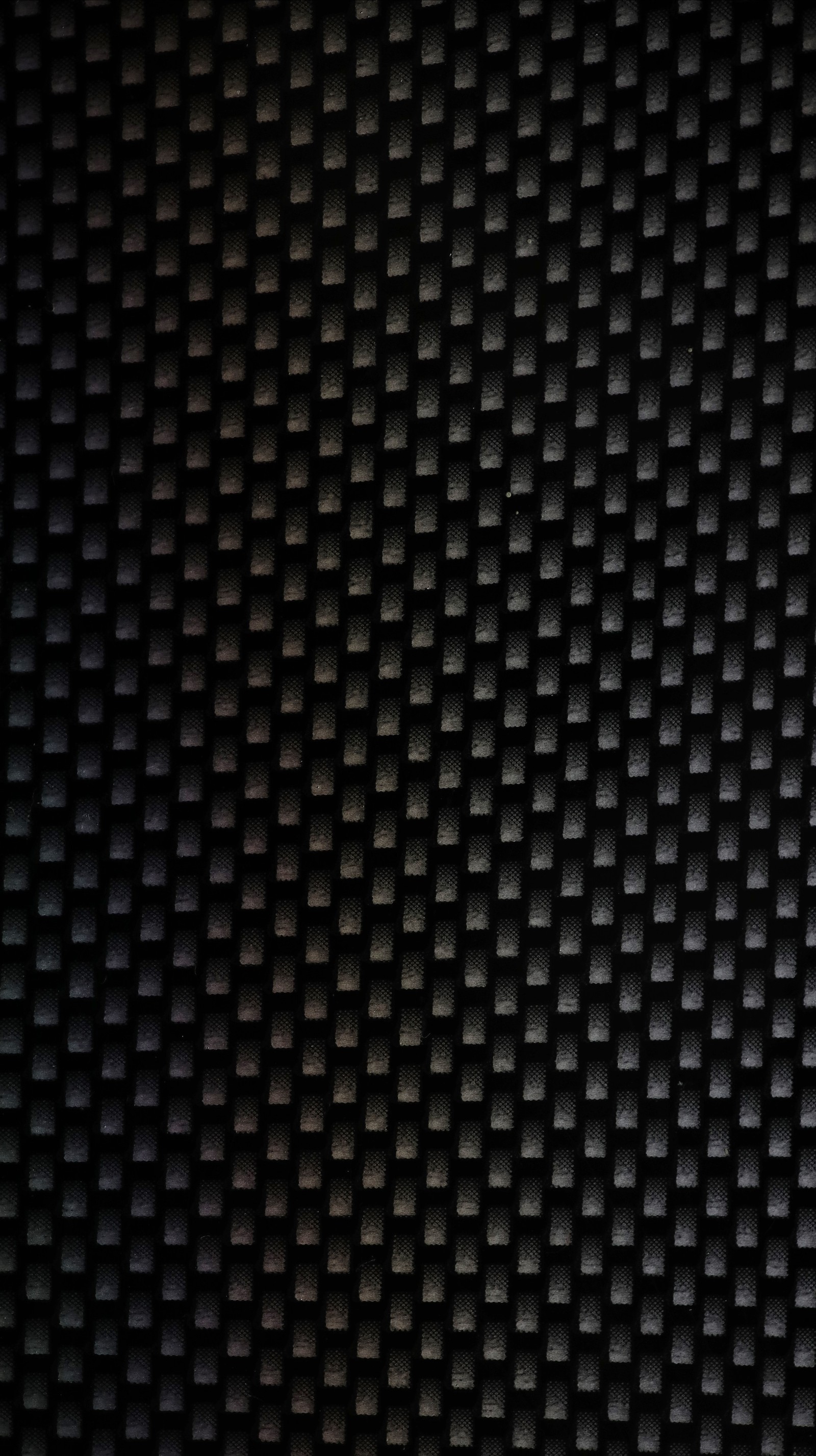 A close up of a black background with a pattern of squares (black, carbon, fiber, minimal, pattern)