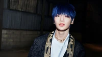 Yang Jeong In (아이엔) from Stray Kids in a striking look, showcasing his blue hair and distinctive fashion for the 'Back Door' era.