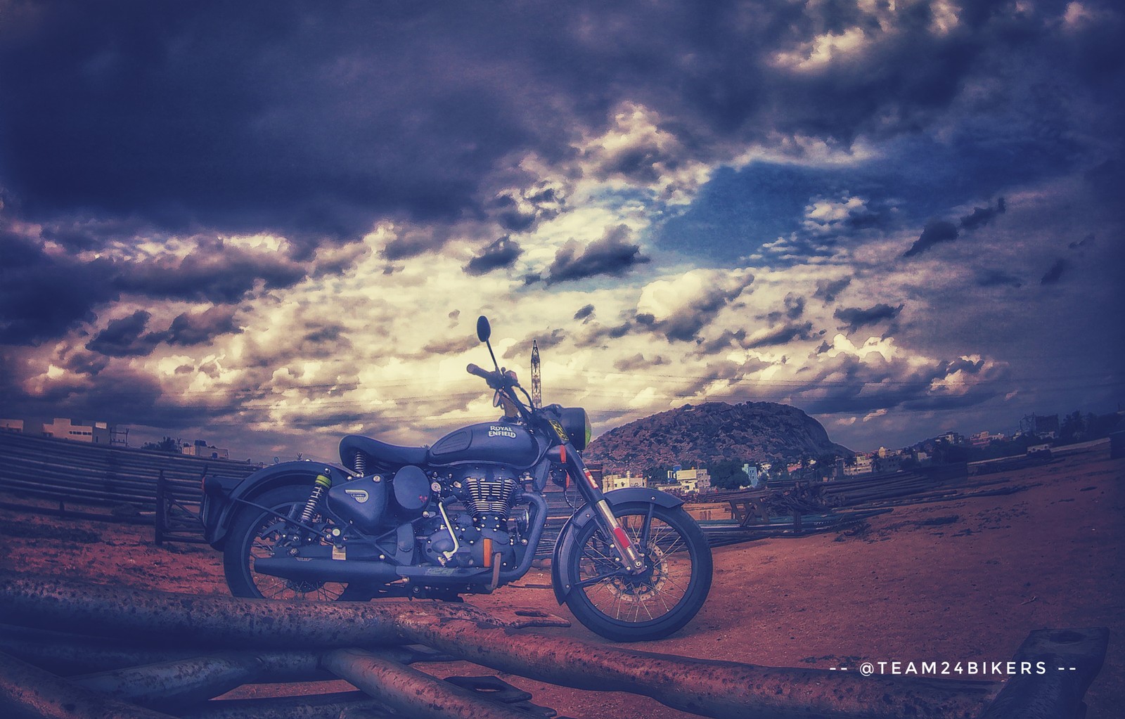 There is a motorcycle parked on the dirt in the desert (mujju24, royal enfield mujju24)