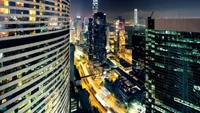 Nighttime Cityscape of a Metropolis Skyline with Towering Skyscrapers and Illuminated Streets.