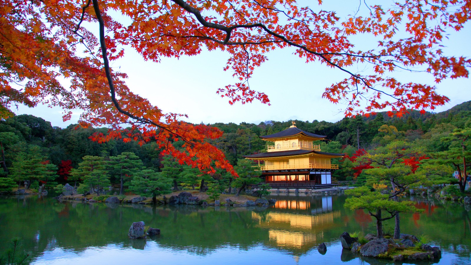 Arafed view of a pond with a building in the background (travel, nature, reflection, tree, leaf)