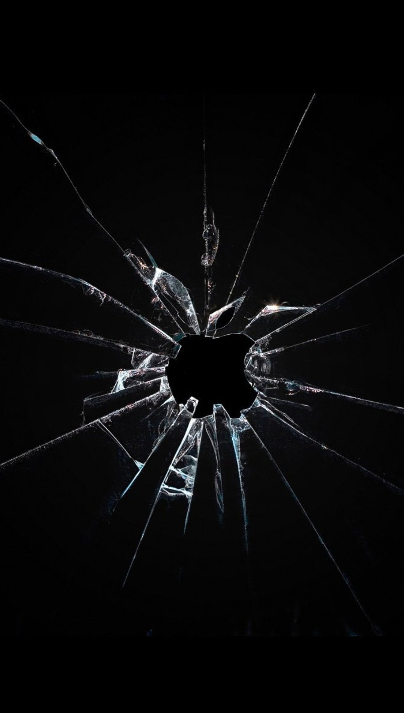 A close up of a broken glass window with a black background (broken, glass, pattern)