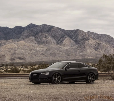 Audi S5 with Vossen wheels against a dramatic mountain backdrop.