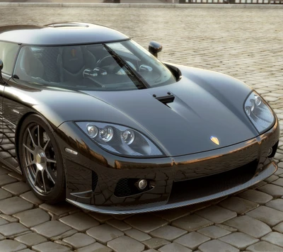 Sleek Black Sports Car on Cobblestone Surface