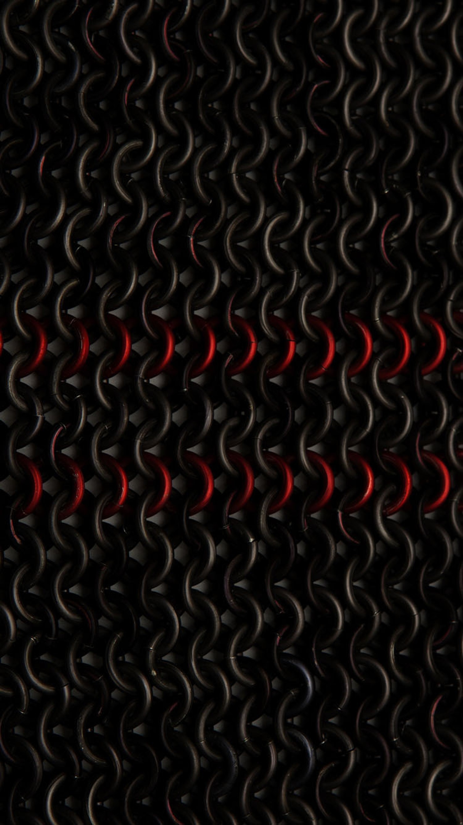 There is a lot of black and red rings on a black surface (black, chain, red)