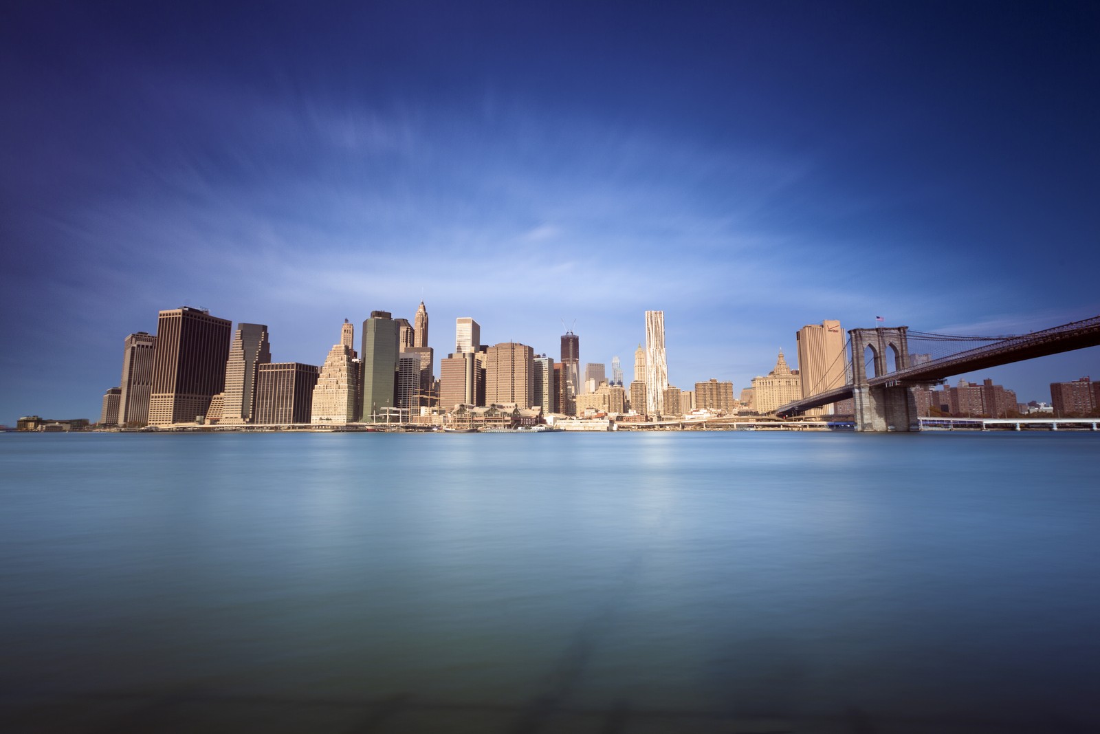 Arafed view of a city skyline with a bridge over a body of water (brooklyn bridge, city, skyline, cityscape, daytime)