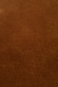 Texture de cuir brun caramel riche avec des motifs subtils