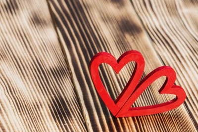 Red Wooden Hearts Symbolizing Love on a Rustic Surface