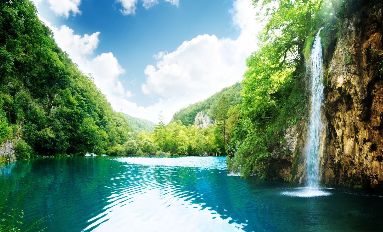 Une cascade au milieu d'une rivière entourée d'arbres (ressources en eau, plan deau, la cascade, nature, eau)