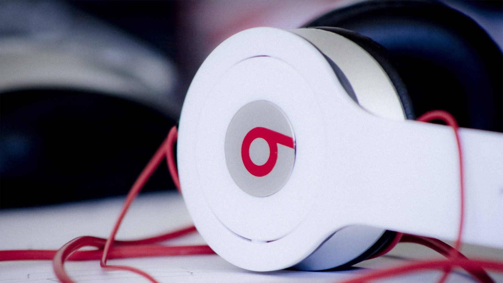 A close up of a pair of headphones with red cords (headphones, gadget, audio equipment, electronic device, technology)