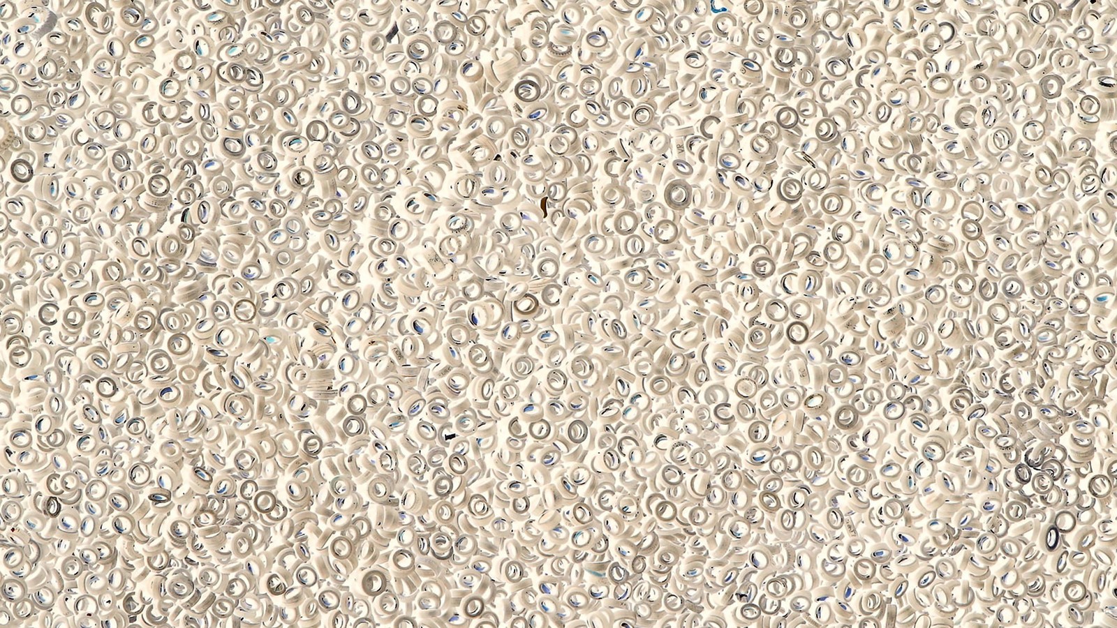 A close up of a white and blue wall with a lot of circles (texture, pattern, material, ios, grasses)