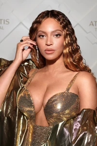 Beyoncé in a glamorous metallic outfit at a high-profile event.