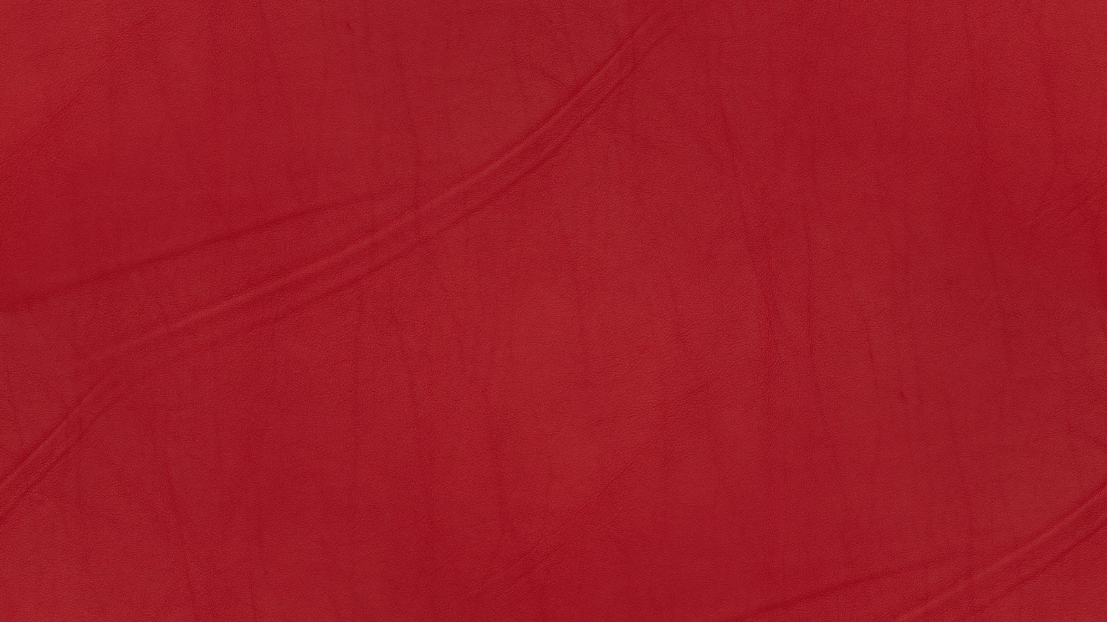 A close up of a red cloth with a white background (orange, red, silk, maroon, magenta)