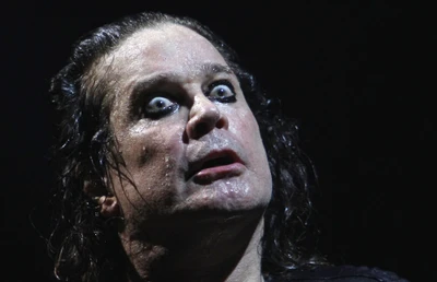 Ozzy Osbourne in a dramatic performance, embodying the essence of rock and roll with intense expression and striking makeup.