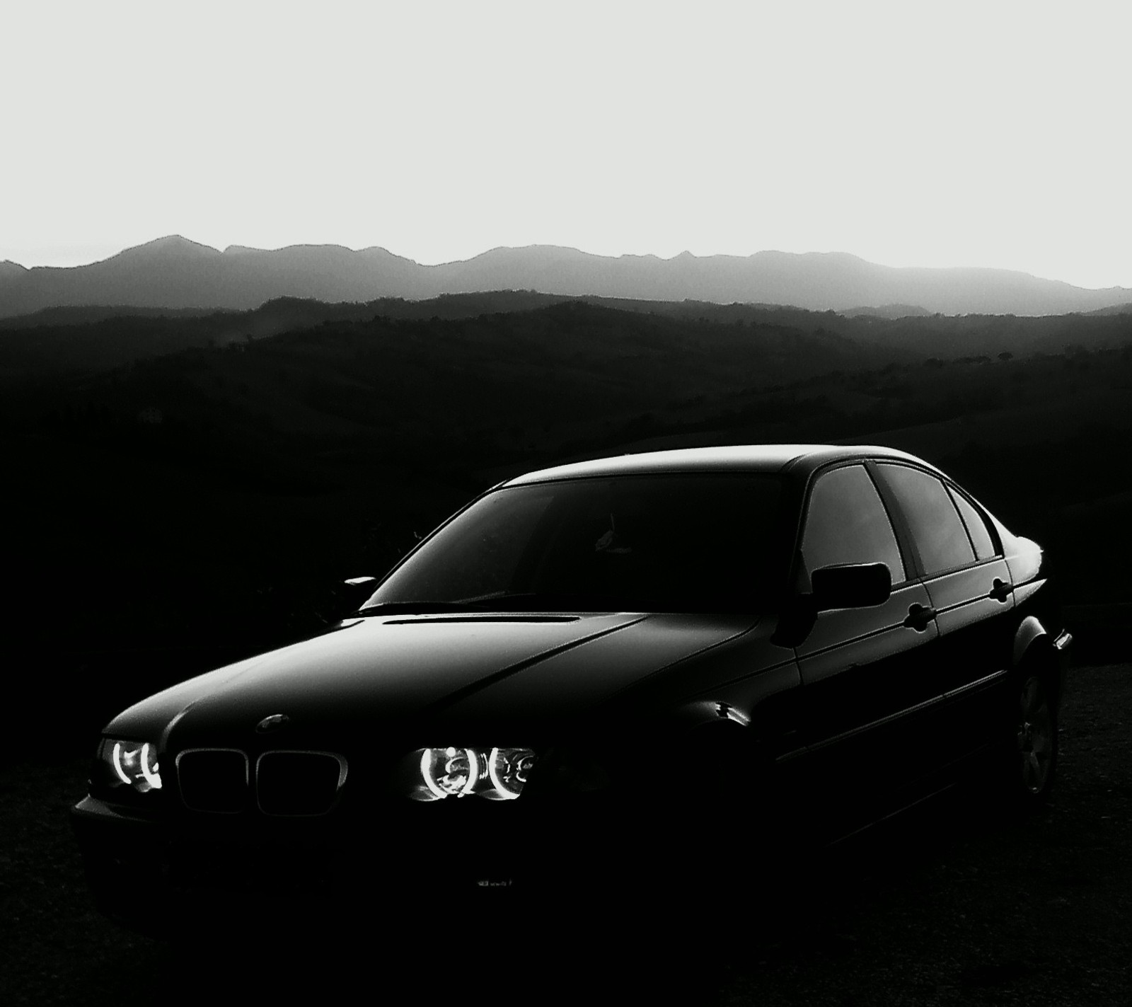 Arafed black and white photo of a car parked in a field (3 series, bmw, e46)