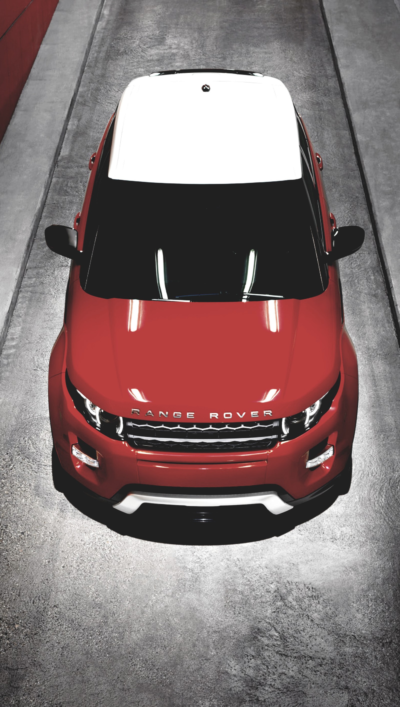 A close up of a red car parked on a street (car, evoque auto, range rover, range rover evoque)