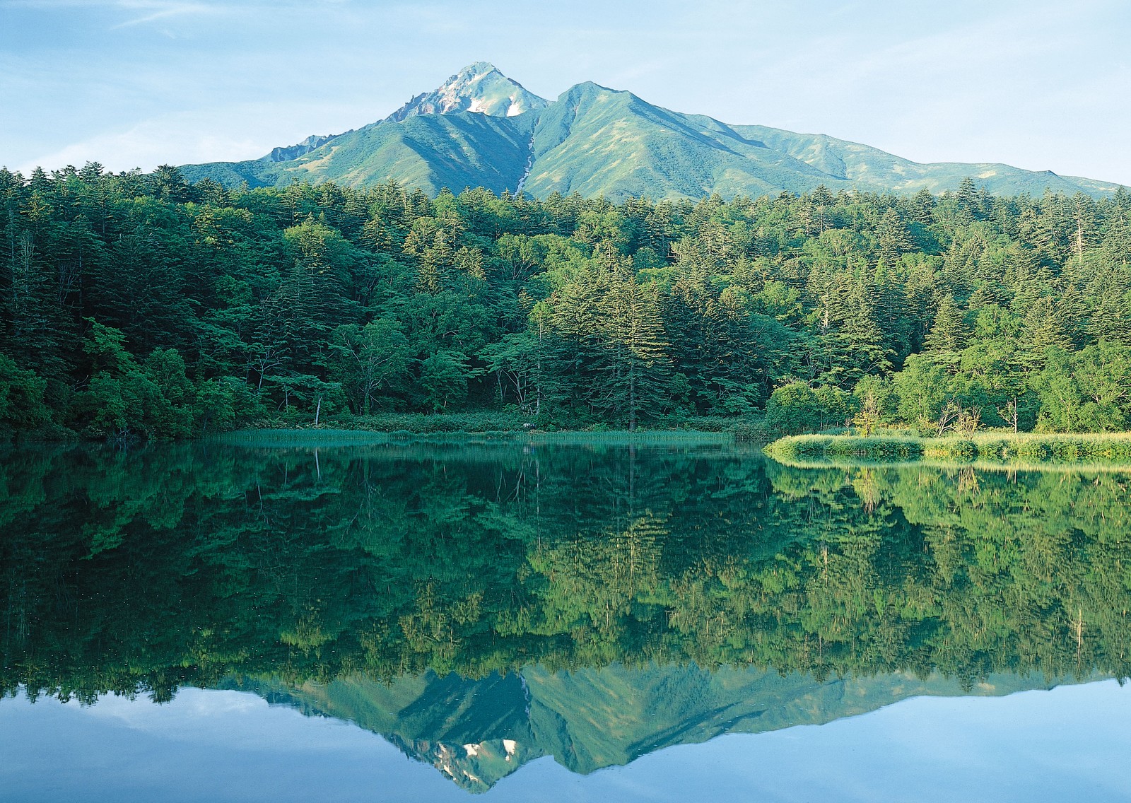 In der ferne ist ein berg mit einem see im vordergrund zu sehen (reflexion, natur, wasser, wasserressourcen, see)