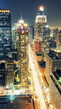 Vibrant Cityscape at Night: Illuminated Skyscrapers and Busy Streets