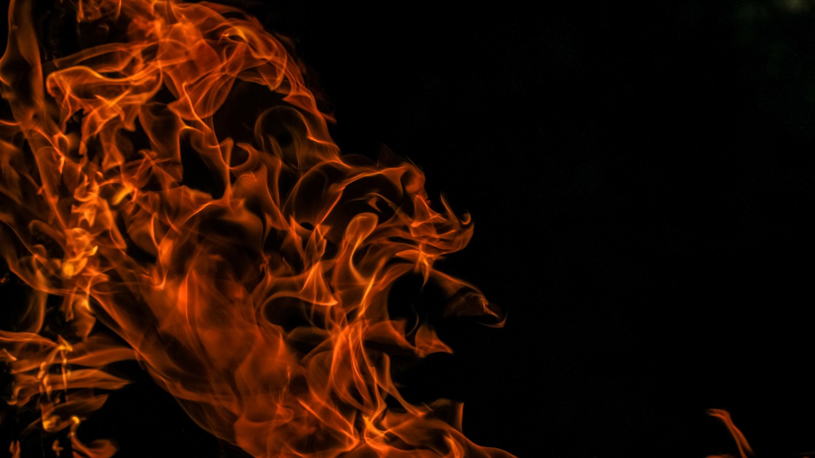 Flames are rising from a black background with a black background (flame, heat, fire, smoke, graphics)