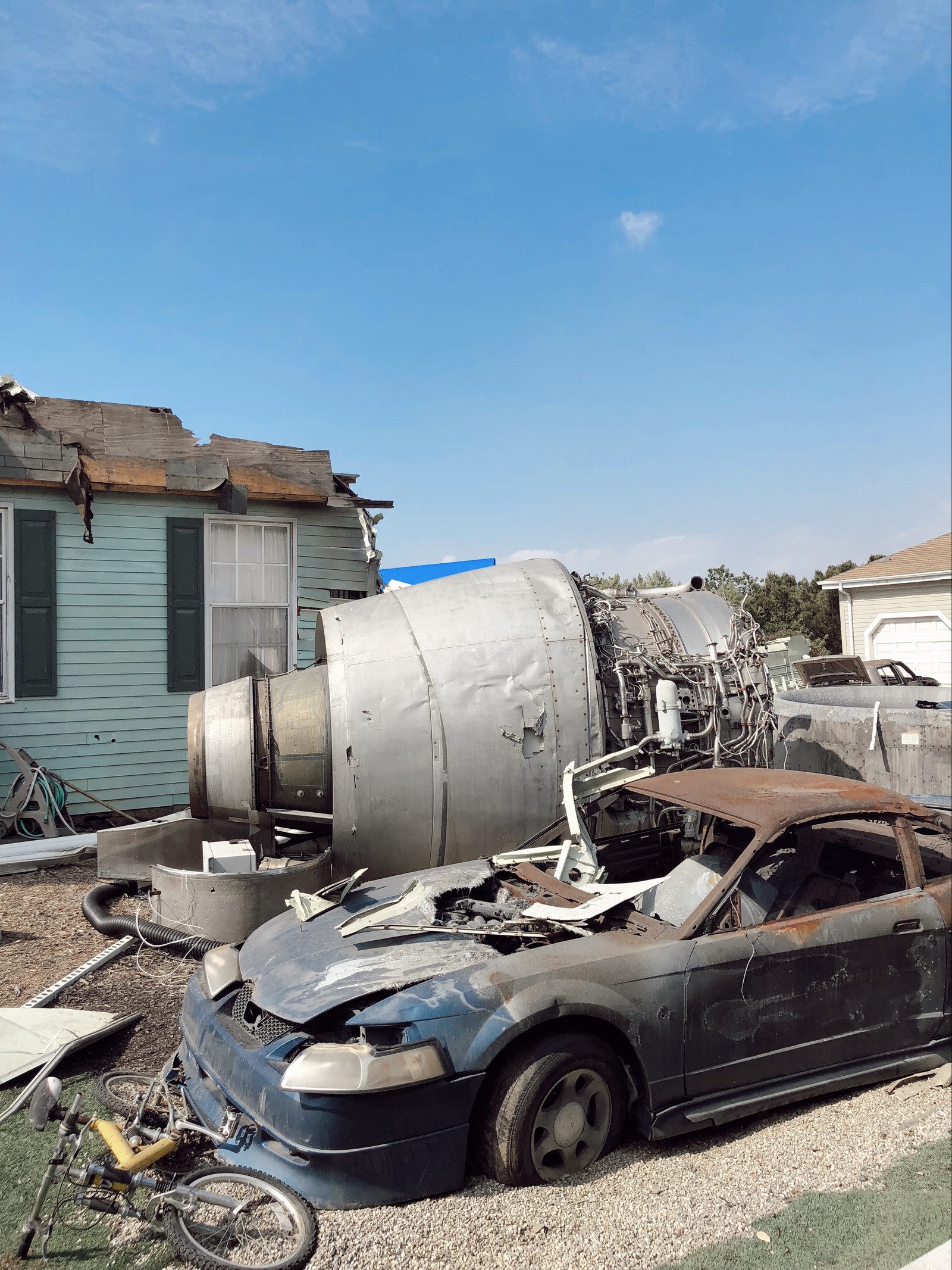 There is a car that is parked in front of a cement mixer (king, tire, wheel, automotive tire, rim)