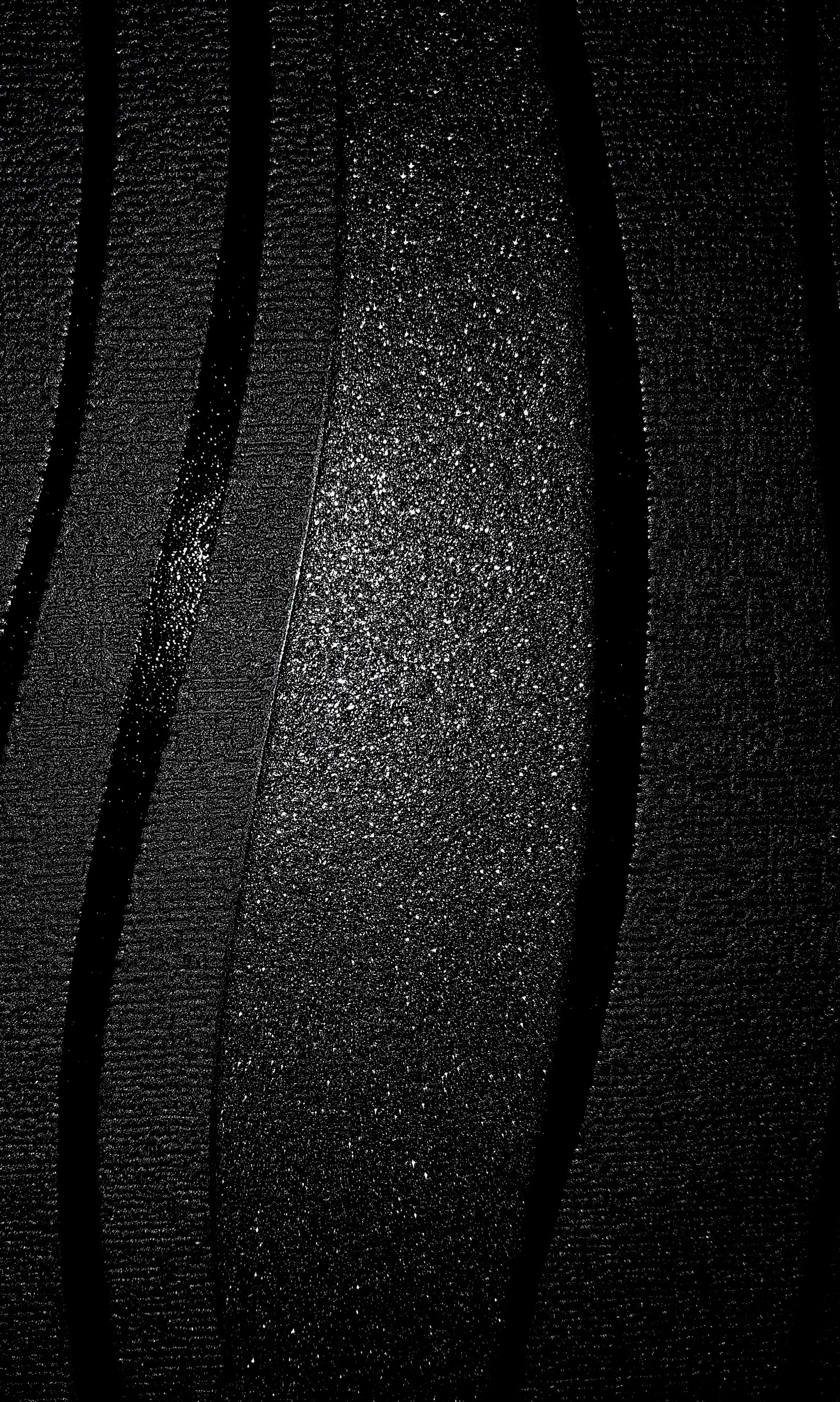 A close up of a black and white photo of a black surface (abstract, black, glitter)