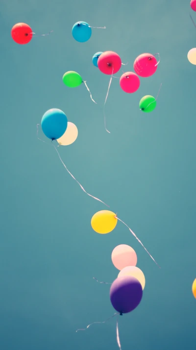 Colorful Balloons Floating Against a Clear Sky